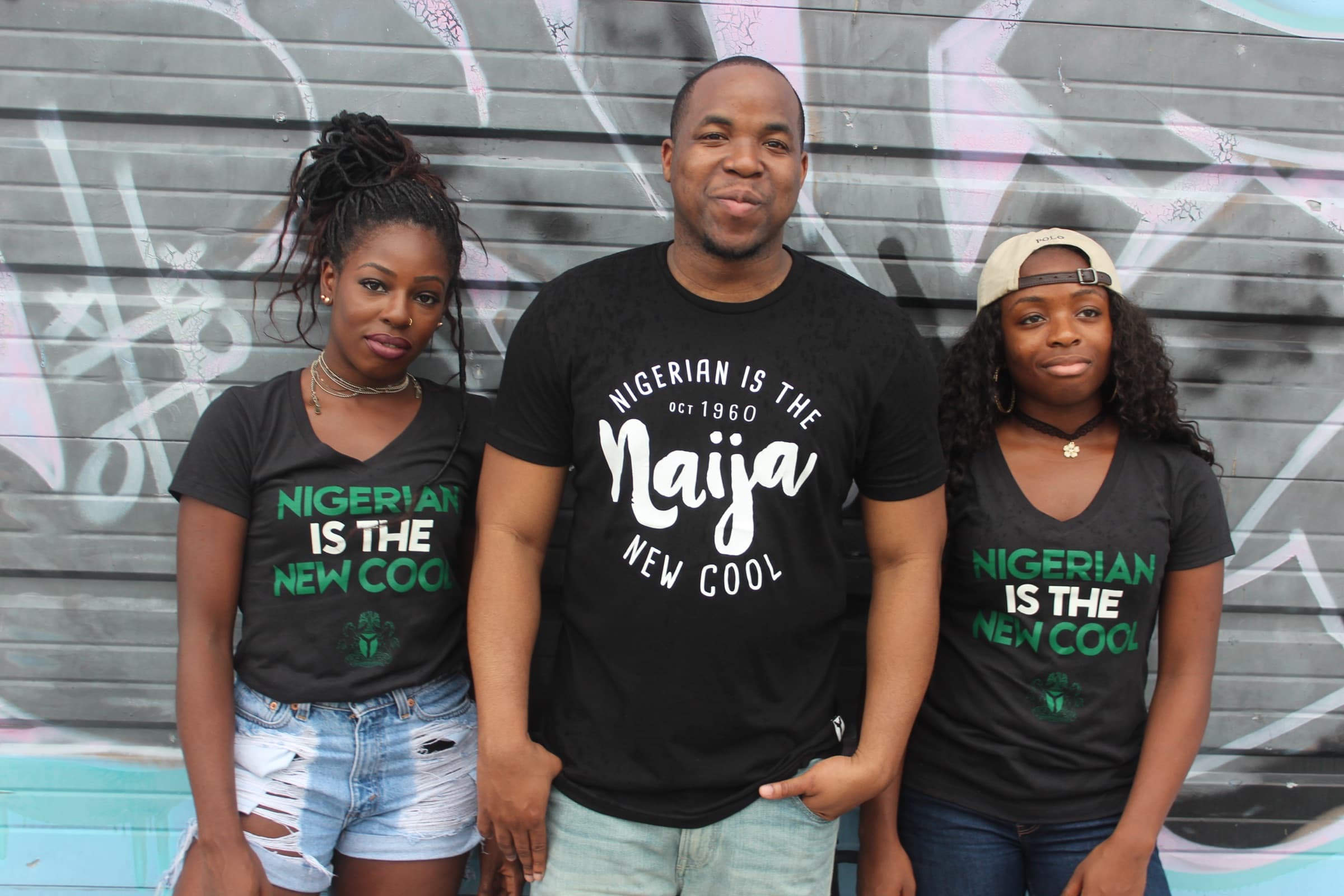 Three NITNC community members photographed against a painted wall